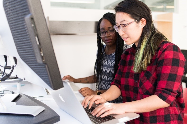 two people using computers and collaborating